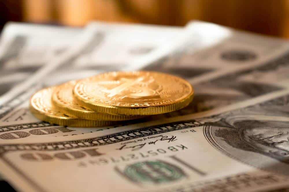 Bitcoins and US Dollar bills.