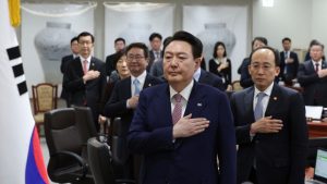 South Korean President Yoon Suk Yeol salutes the national flag during a cabinet meeting at the presidential office in Seoul, South Korea 