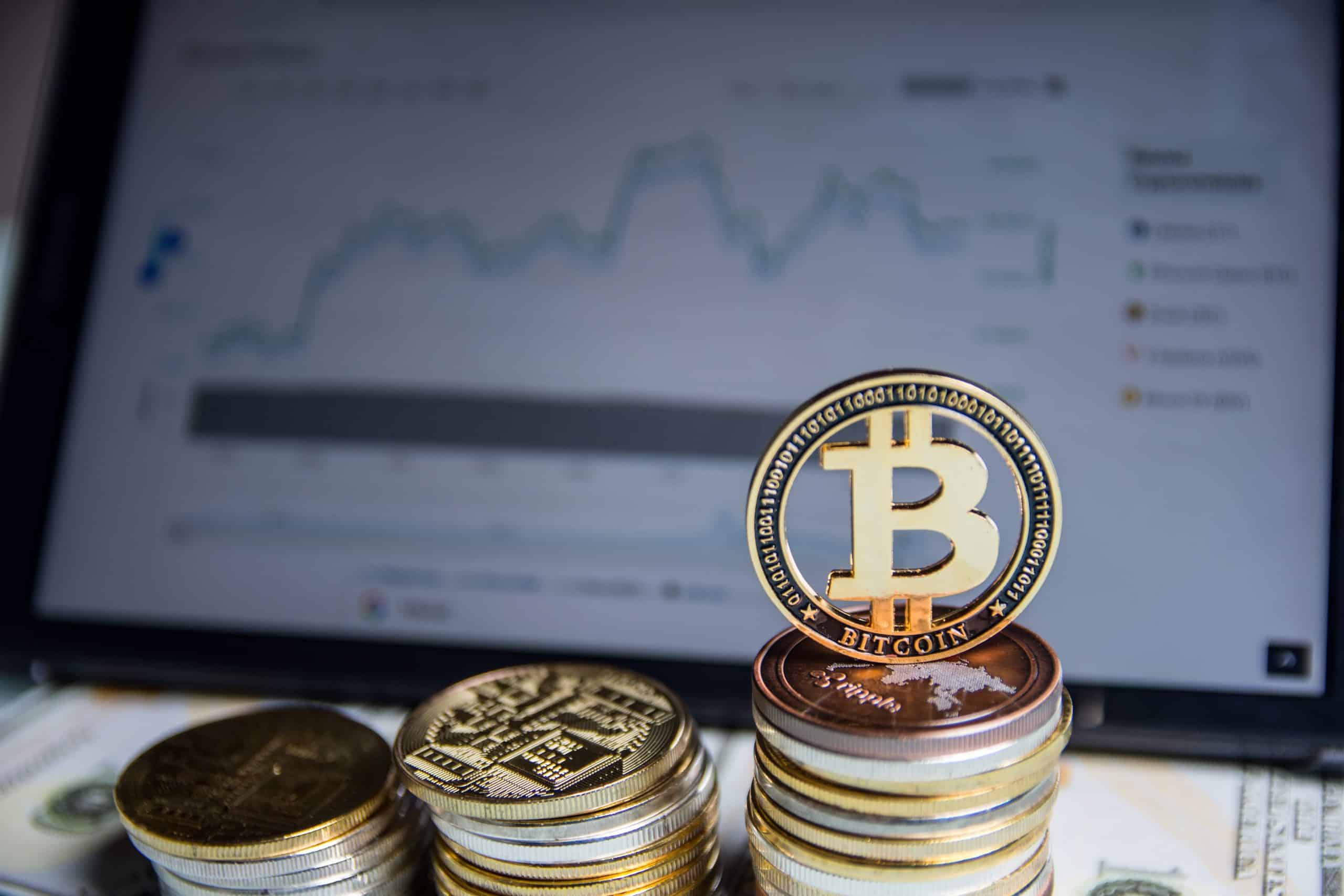 Bitcoin coins in front of laptop