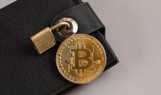 Bitcoin coin on wallet with a lock on it