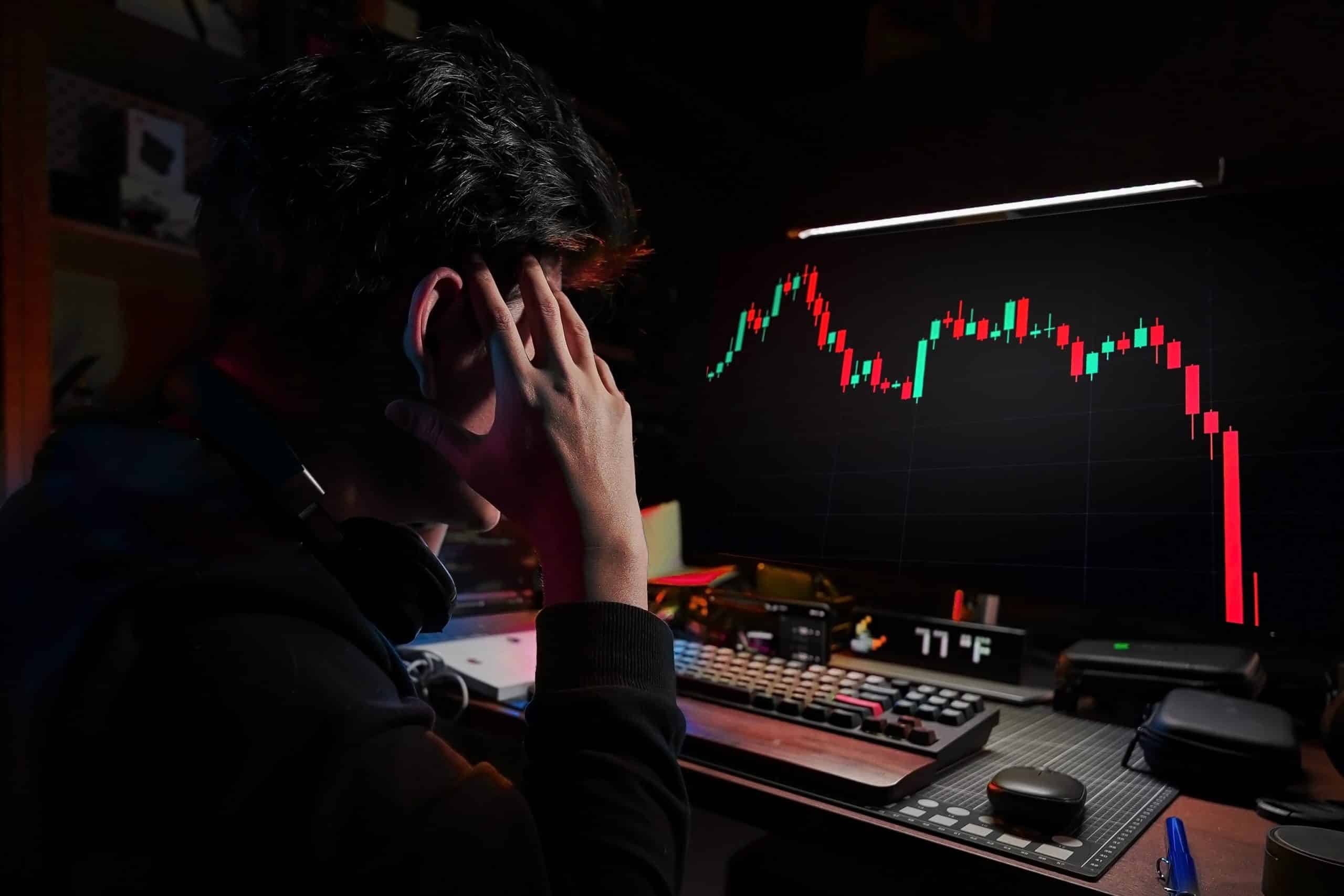 Man watching price chart fall