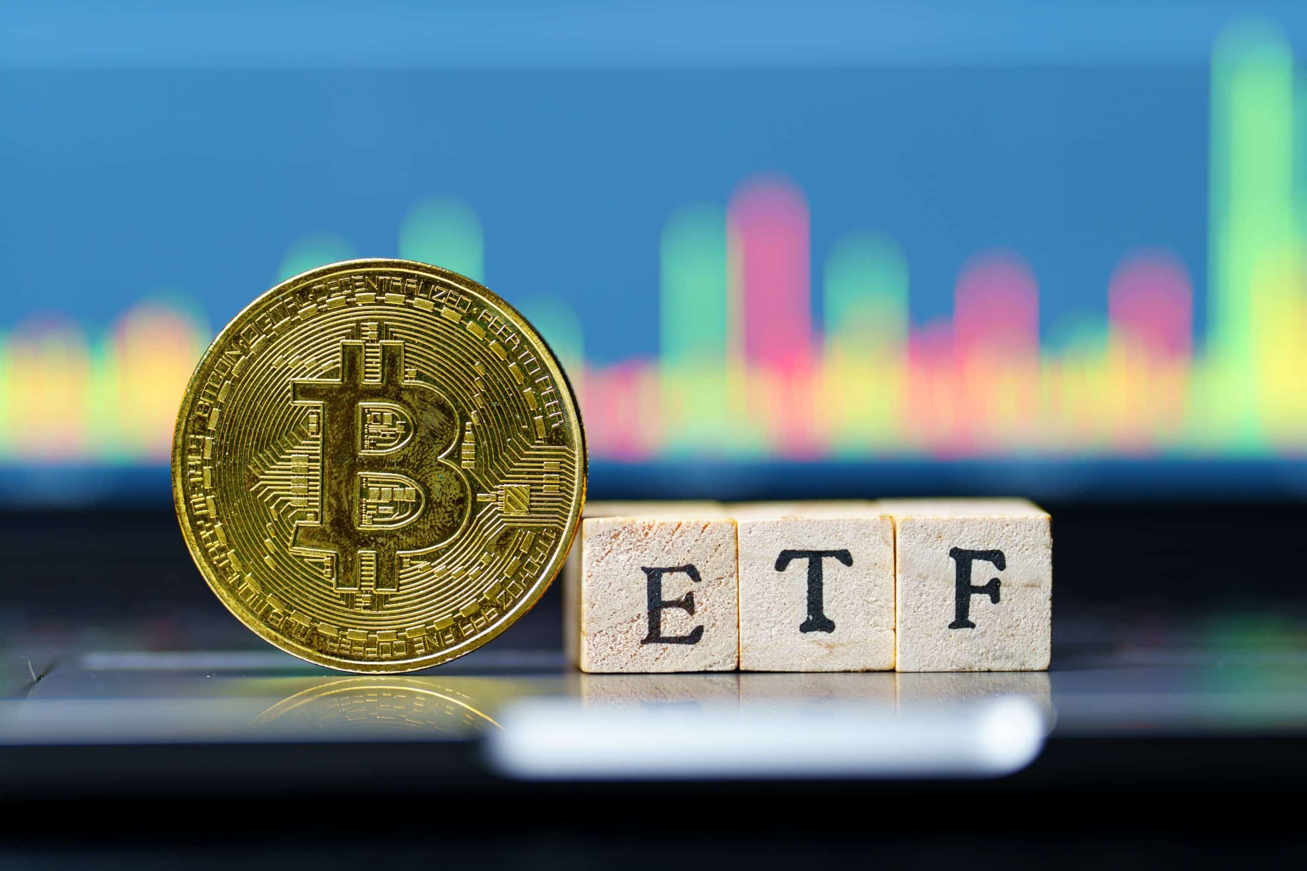 Bitcoin coin next to ETF blocks